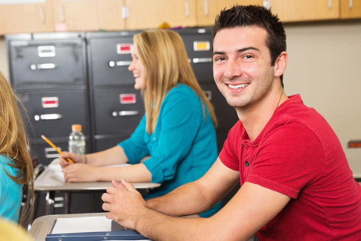 Adult Students _ High school or college student smiling in class iStock_175197894.jpg